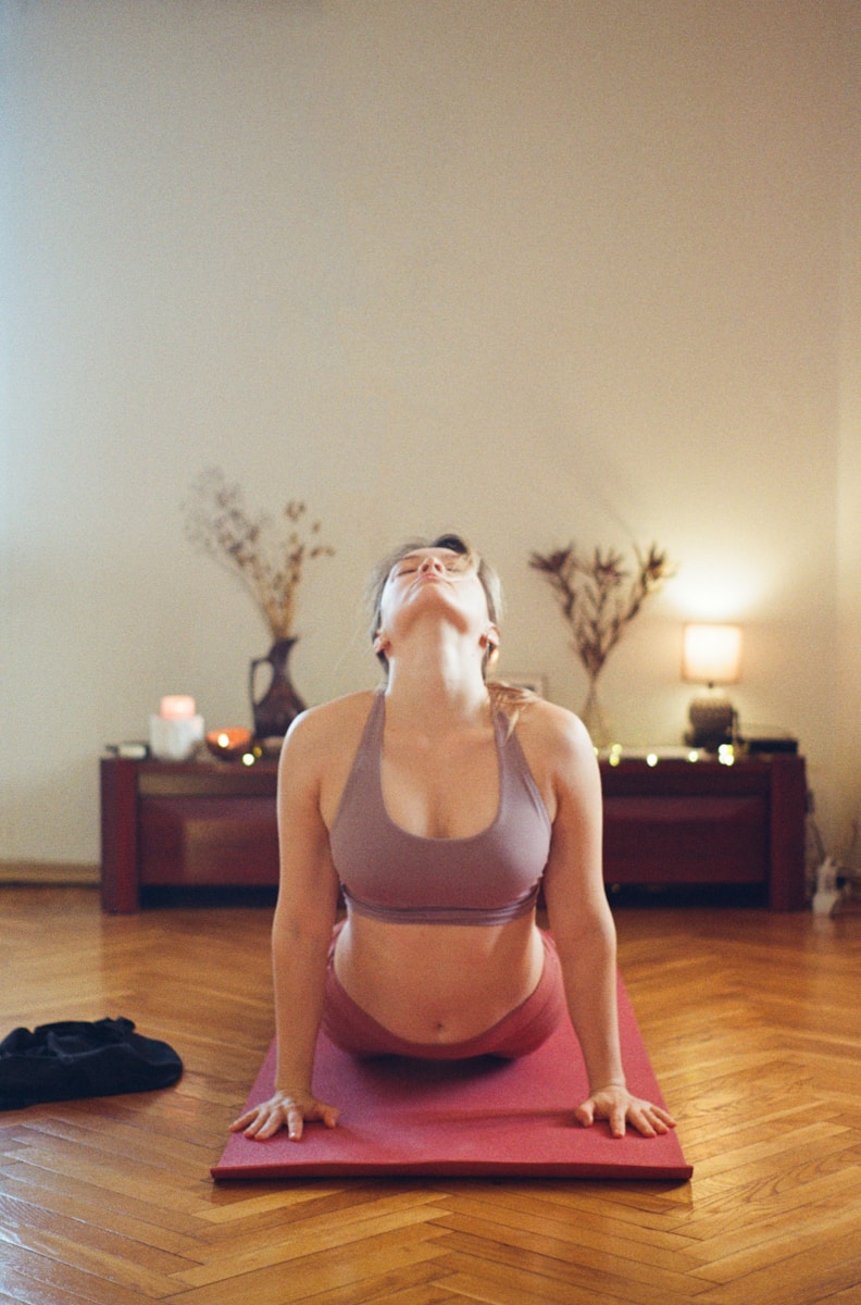 Photo by Leo Sokolovsky a woman is doing yoga on a mat
