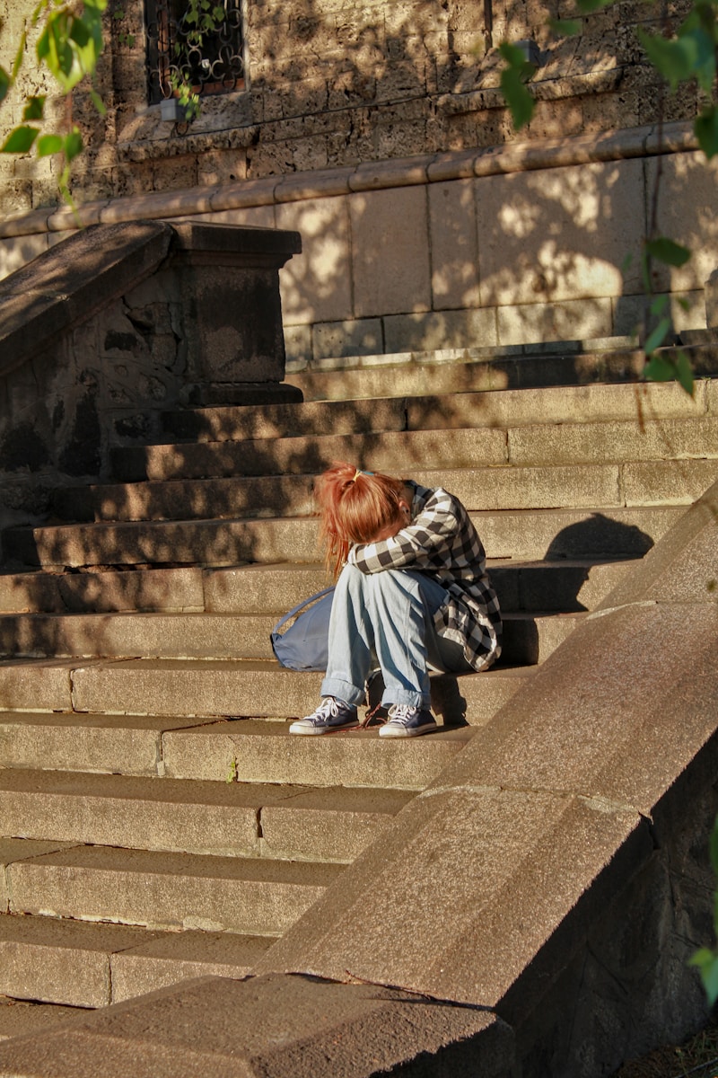 Photo by Zhivko Minkov woman in black and white dress sitting on concrete stairs
